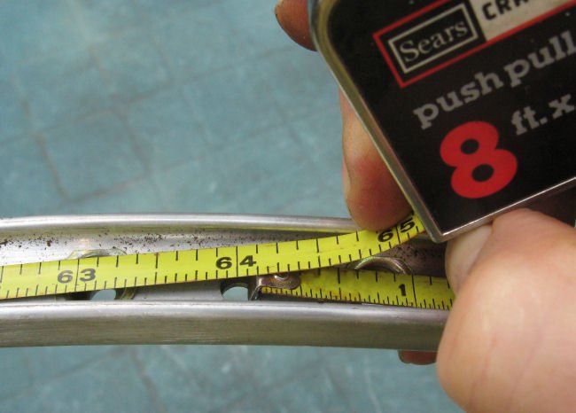 a close-up of a measuring tape around a bike wheel